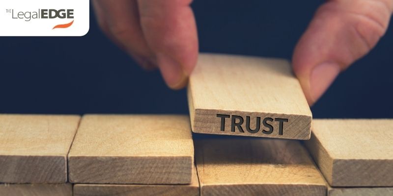 good faith represented by person putting block of wood down in puzzle space with trust printed on the edge