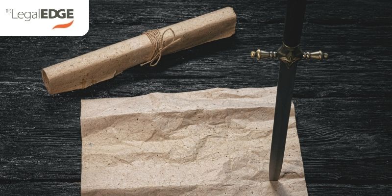 Contractual discretion represented by double edged sword sticking in paper contract on wood table